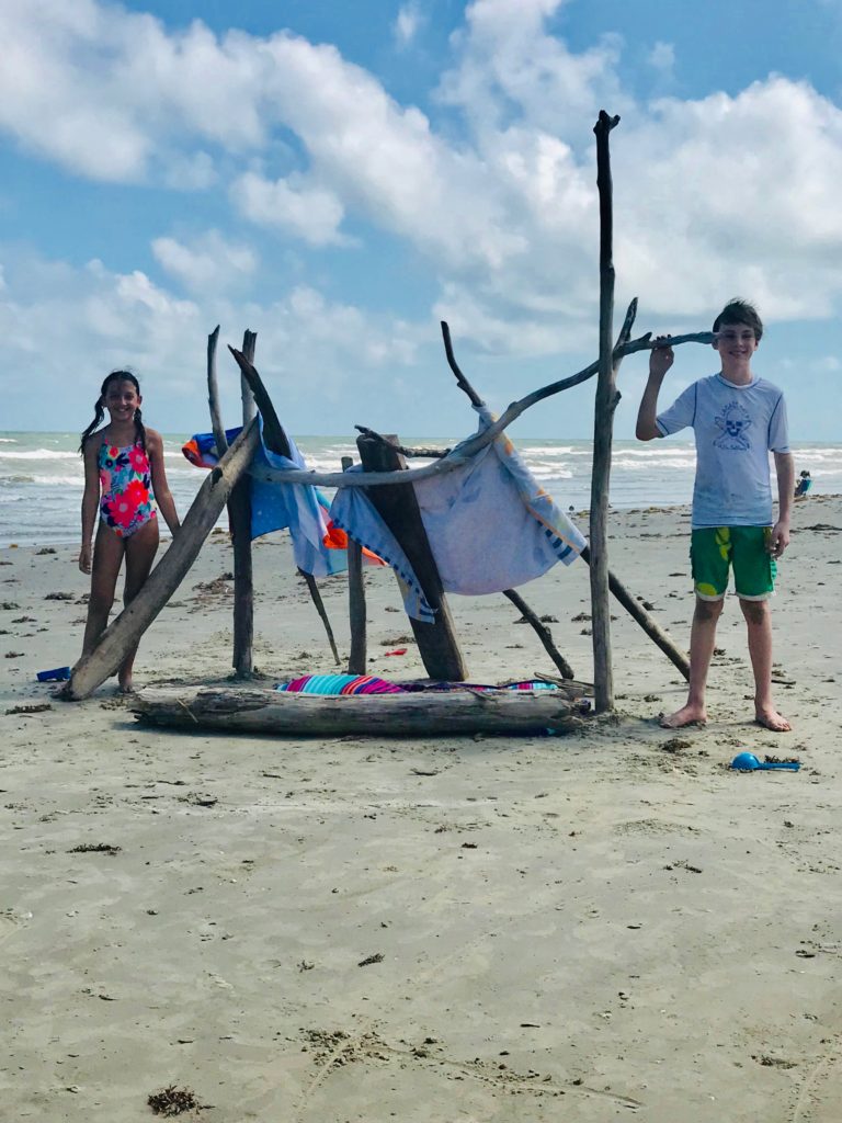 they build the fort with driftwood and beach towels